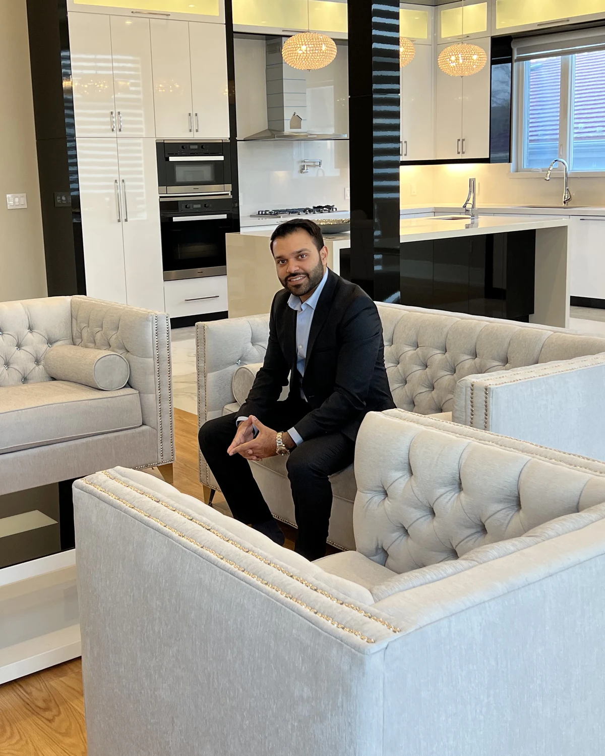 Usman Gillani seated in a modern home